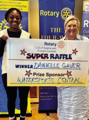 Rotarians Destiny McClendon (left) and Jennifer Pennington present an inflatable kayak valued at $300 from prize sponsor Watersports Central to Rotary Raffle Week 29 winner Danielle Gaver, who was unavailable for the photo. CONTRIBUTED