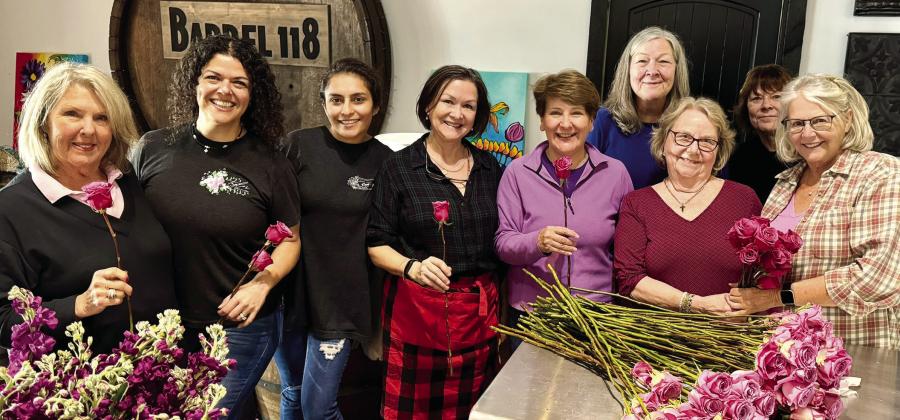 Volunteers from The Artisans Village helped prep hundreds of roses alongside Myrna Taylor (second from left) from Taylor Event and Floral Design. EMMA CLAUSE/Staff
