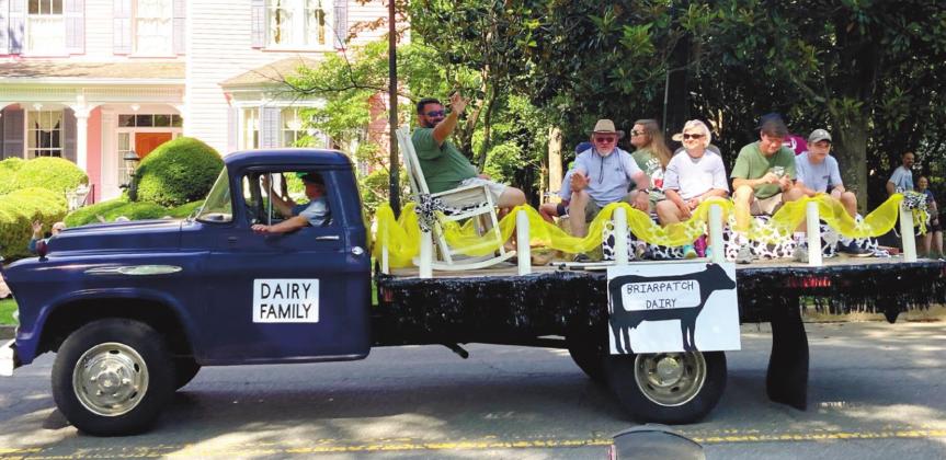 The Swafford family waves to the crowd from the Dairy Farm Family of the Year parade float. LYNN HOBBS/Staff