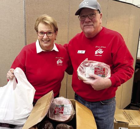 Volunteers prepare food for distribution. CONTRIBUTED
