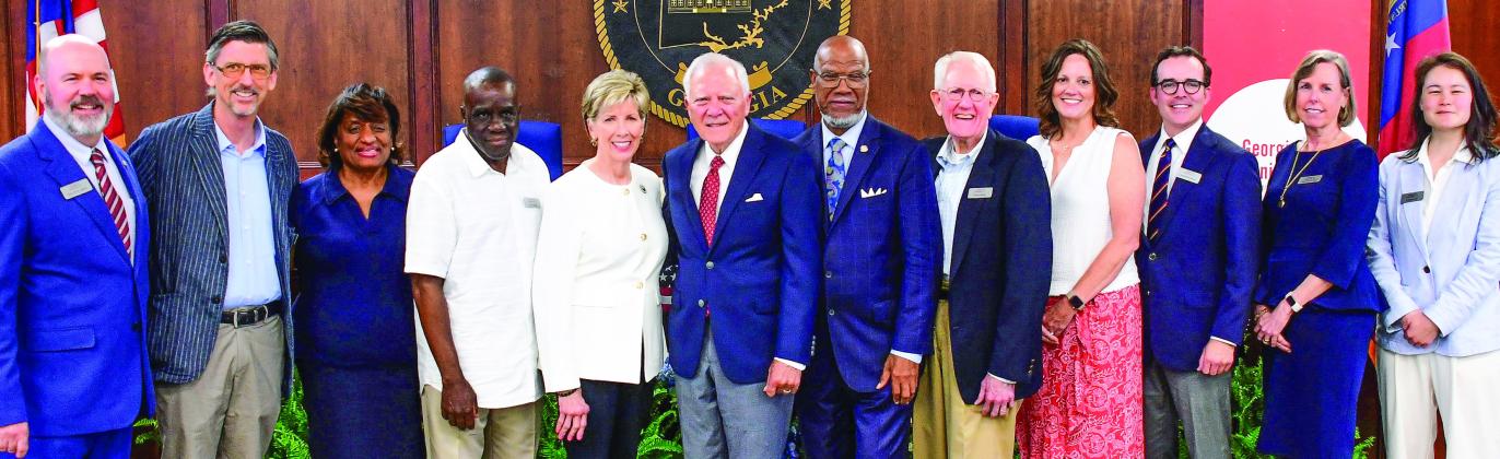 Members of Georgia Humanities posed with panelists Cathy Cox, Gov. Nathan Deal, and Legislator Calvin Smyre shortly before their discussion on democracy and the current condition of state and federal politics took place. IAN TOCHER/Staff