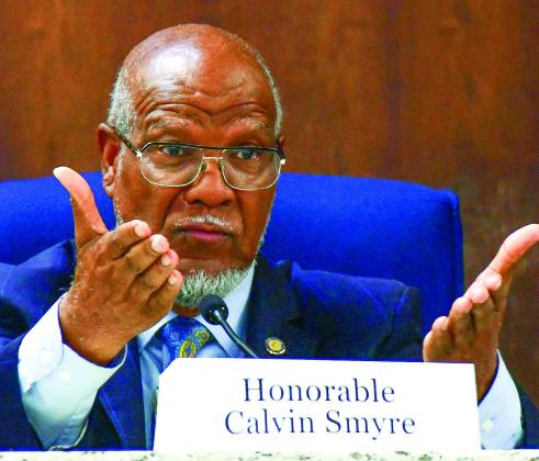 Former state legislator Calvin Smyre, who earned the title, “Dean of the House,” after initially being elected in 1974 as a 26-year-old, gestures to the audience while making a point about the importance of preserving democracy in government. IAN TOCHER/Staff