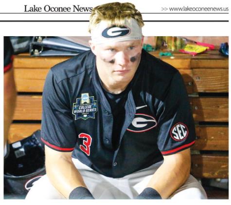 Georgia catcher Daniel Jackson sits in the dugout contemplating what might have been after the Bulldogs’ 11-4 loss to Oklahoma on June 17. LANCE McCURLEY/Staff