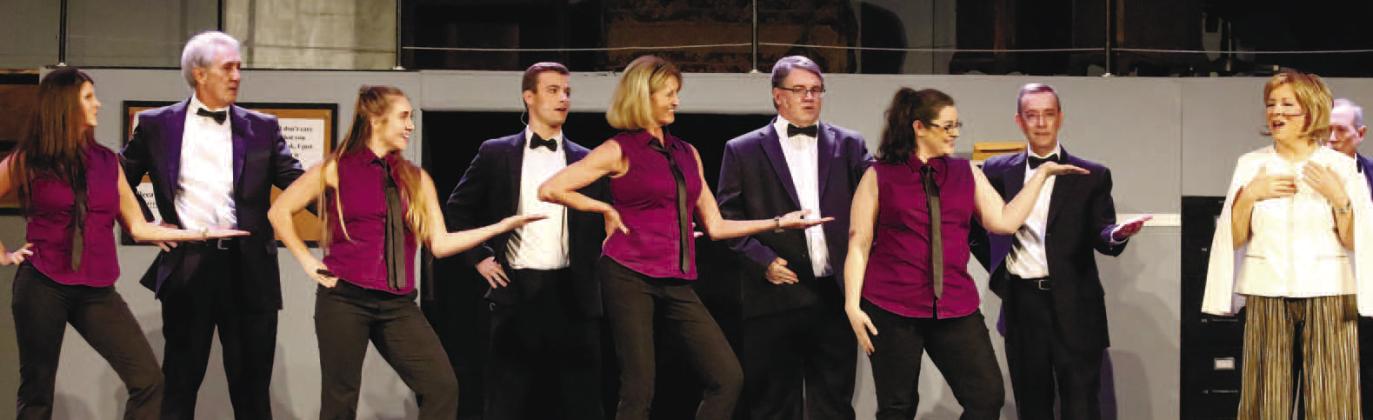 The ensemble (including choreographer Mo Brewer, far left) sing and dance on stage for 9 to 5: The Musical.