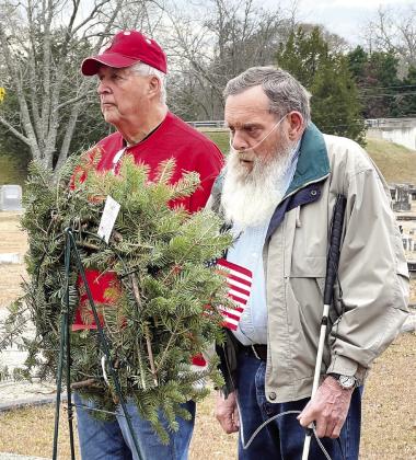 Veterans placing ceremonial wreaths at the Greensboro City Cemetery. Bob Pluta in red hat and shirt is Lake Oconee Lodges Chaplain