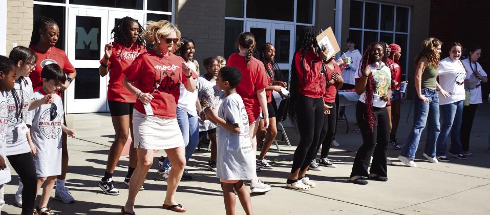 When the music started, kids and teachers began a spirited line dance in front of Morgan County High School. (T. MICHAEL STONE/Staff)
