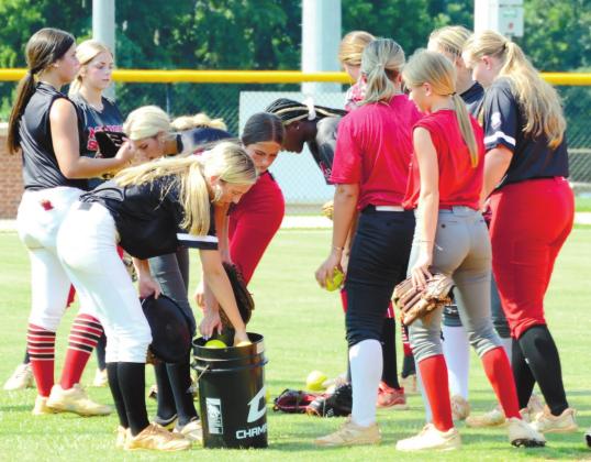 A group of Lady Dogs huddle during Tuesday’s practice. BRENDAN KOERNER/Staff