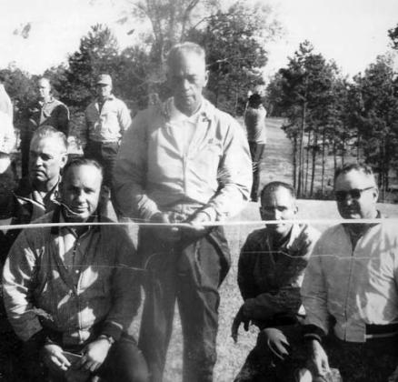 Surrounded by benefactors and inaugural members of Pine Knoll Country Club, course founder and builder Bubba Ellis prepares to cut the ribbon and officially open what is now Uncle Remus Golf Course. Back row, l-r: Johnny Harrell, Lex Rainey, Dee Hewitt and Tom Saxton; front row, l-r: Neil Hewitt, Henry Watterson, J.T. Gregory, Archie Swymer, Ellis, Melvin Harrell and Dick Stribling. Then-14-year-old Johnny Harrell provided the photo early this year, URGC Superintendent Michael Benton said. CONTRIBUTED