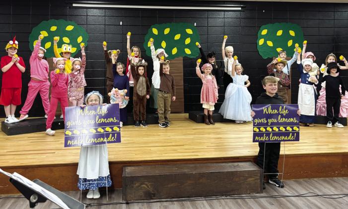 Dressed as Lemonade storybook characters, young Gatewood actors hold up lemons while others display signs reminding everyone: “When life gives you lemons, make lemonade!” EMME CLAUSE/Staff