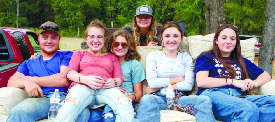 Cade Richter, Emily Pope, Allison, Ashtyn and Laina Richter are more than comfortable on their couch at the back of their truck