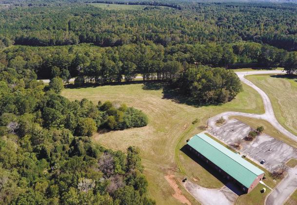 The land across Highway 44 from the former Athens Tech building (lower right) is being considered for development of a 364-acre light industrial park. The property is currently located in Greene County but the developer is asking for it to be annexed to the City of Greensboro. MARK ENGEL/Staff
