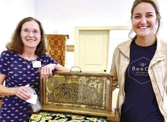 BeeCo Apiaries’ Mary Lacksen (left) and her daughter-in-law Caroline Lacksen exhibit a live honeybee hive during their visit to Eatonton’s Old School History Museum last Sunday. CONTRIBUTED