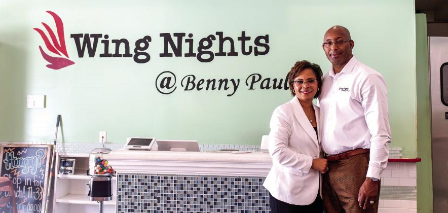 Brince and Emily Benford, owners of Wing Nights at Benny Paul’s, pose inside their restaurant in downtown Madison. The husband-and-wife team opened the business seven years ago and will celebrate five years at their current location in 2027. SKYLA MORRIS/Staff