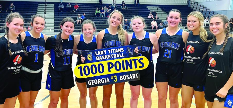 Lake Oconee Academy senior Georgia Bosart  (center) poses for a picture with her teammates after scoring her 1,000th point last week. CONTRIBUTED