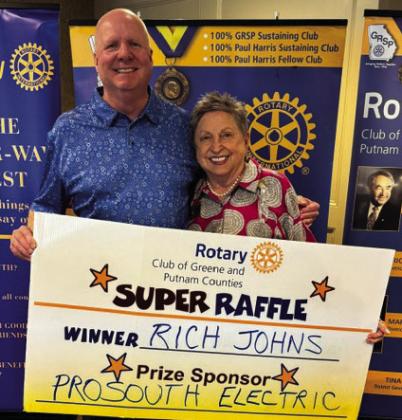 Rotary Raffle Week 38 winner Rich Johns accepted from Rotarian Micki Tanner his prize of a $300 Home Depot gift card, sponsored by ProSouth Electric. CONTRIBUTED