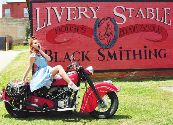 A member of Lifers Car Club poses with her motorcycle. ARELLA CASH/Staff