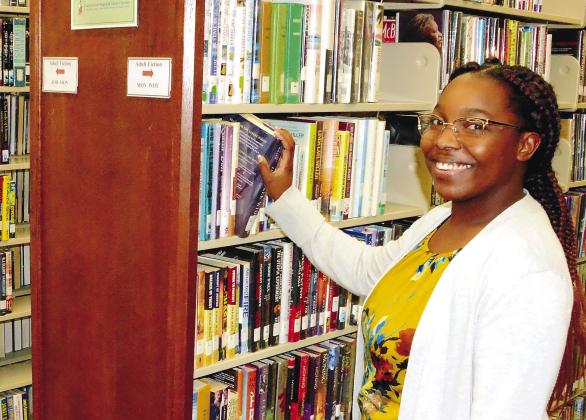 Abby Boatfield couldn’t be happier with her new position as manager of the Eatonton-Putnam County Library and invites anyone interested in what the library offers to come in and meet with her staff. IAN TOCHER/Staff