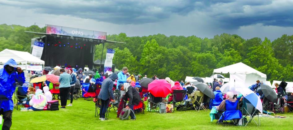 Mother Nature brought strong winds and heavy rain, which changed the program, but the show still went on as attendees huddled under umbrellas and bundled up in rain coats to brace for the elements. LEIGH LOFGREN/Staff