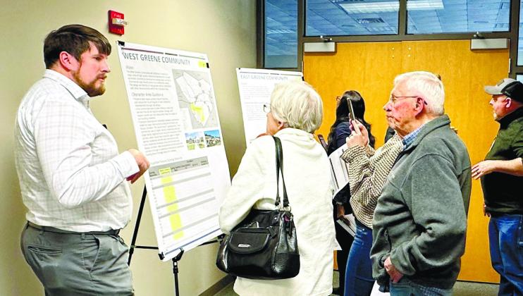 County Assistant Chris Edwards (left) discusses planning initiatives with area residents. MAUREEN STRATTON/Staff