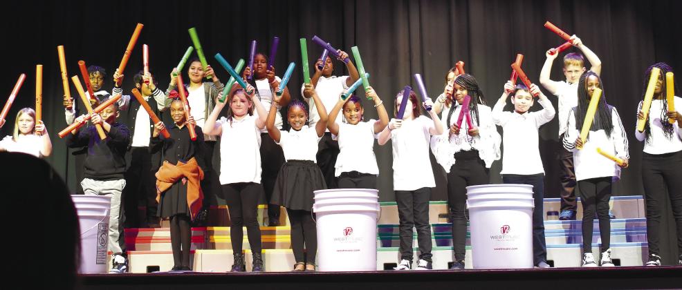 Fourth-grade students perform the melody line of “I Feel Good” by James Brown on Boomwhacker percussion tubes. LENA HENSLEY/Staff