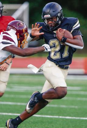 Greene County running back Johnathan Lawrence (27) prepares to stiff-arm a Hancock Central defender during last week’s scrimmage. LANCE McCURLEY/Staff