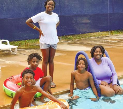 Posing for the photo at the Putnam County swimming pool are, left to right, middle schoolers Jacob White, Bryce Leslie, Harmony Swimey, Rasha Ellison, and camp instructor Rakeena Griffin.