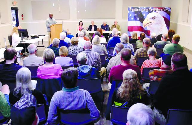 A full house faced Putnam County District 3 commissioner candidates last Thursday at Lake Oconee Lutheran Church Community Center, where former candidate Charles Trumbo (at podium) served as emcee for the event. IAN TOCHER/Staff