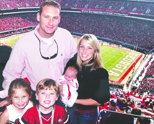 Drew Camp, a former Georgia football player and Madison resident, and his family during a Bulldogs’ game more than a decade ago. CONTRIBUTED