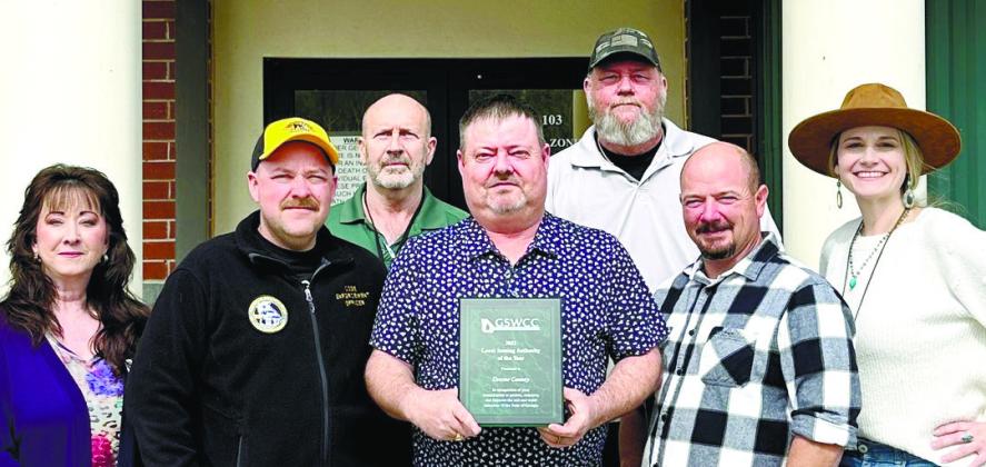 Chuck Wooley, center, and the staff of the Planning & Zoning department were awarded for by the Georgia Soil and Water Conservation Commission. CONTRIBUTED