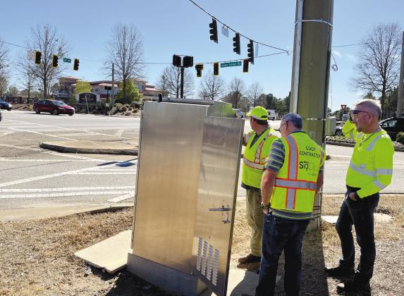 Georgia Department of Transportation workers attempt to find the right timing for new traffic lights at Highway 44 and Linger Longer Road. MARK ENGEL/Staff