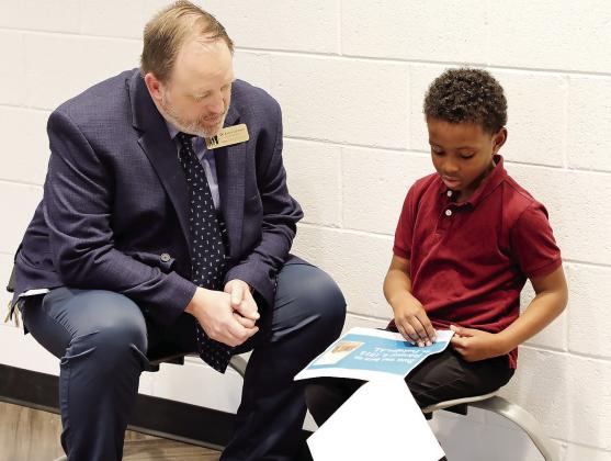 Schmuhl listens to a student’s Black History Month presentation. CONTRIBUTED