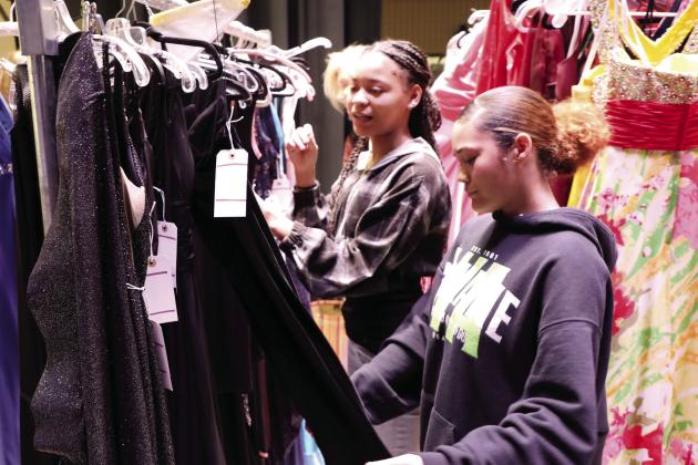 Greene County High School students peruse dresses collected by local volunteers to help provide a fairytale experience. CONTRIBUTED
