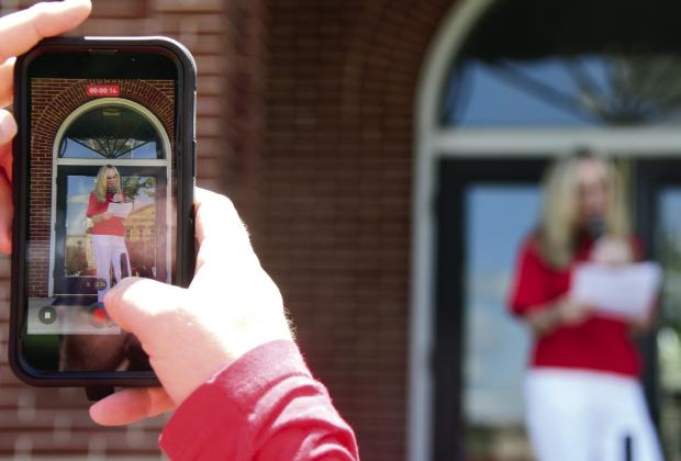 County Commission District 4 candidate Jennifer Ray reads a prepared statement Sunday afternoon in downtown Eatonton. IAN TOCHER/Staff