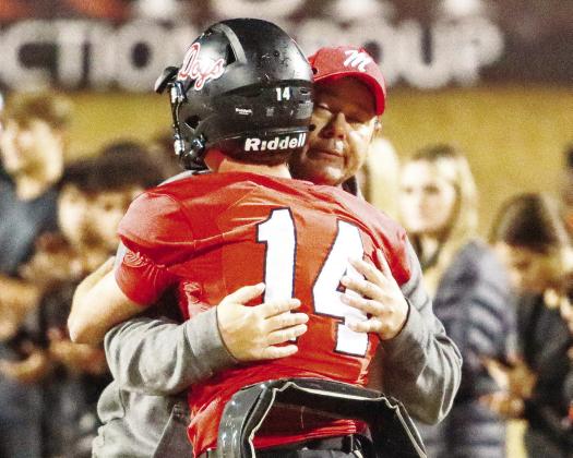 Morgan County head coach Clint Jenkins and quarterback Talan Fuller (14) share a moment after the loss.    LANCE MCCURLEY/Staff