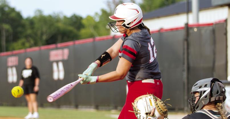 Morgan County’s Maeleigh Gibson swings at a pitch during the Dogs’ season-opening game against Walnut Grove. SKYLA MORRIS/Staff