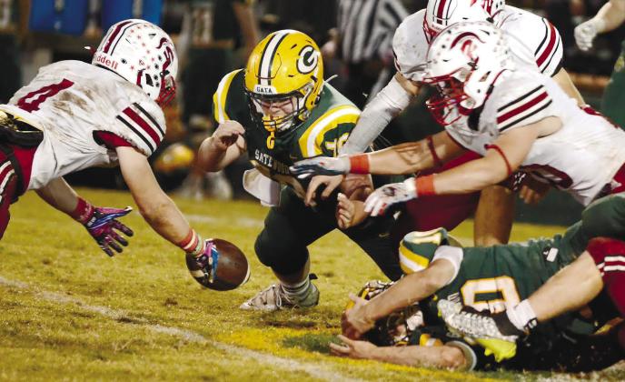 Tyler Middleton (center) made the effort for Gatewood Friday night, but the visiting Spartans came up with the ball after a lategame fumble by Gators quarterback Ames Johnson. IAN TOCHER/Staff