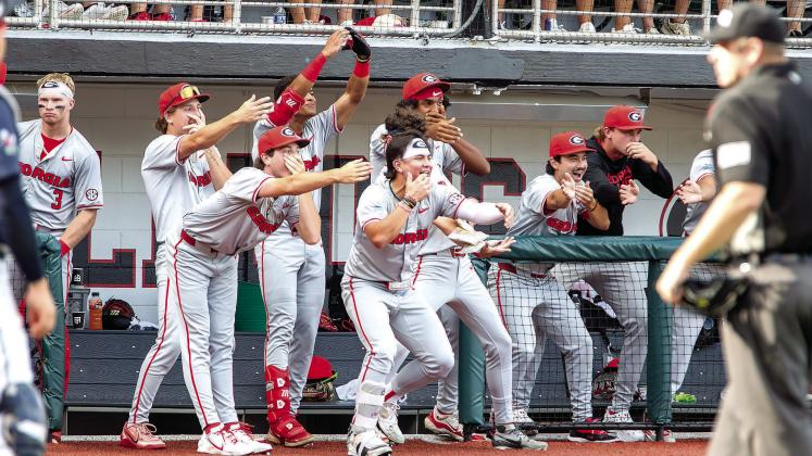 Georgia players celebrate a home run from the dugout during their game against Liberty on Saturday, May 30. SKYLA MORRIS/Staff