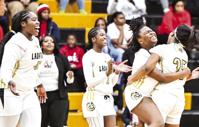 Several Lady Tigers celebrate after knocking off Lake Oconee Academy this past Saturday. CHARLES JORDAN/Staff