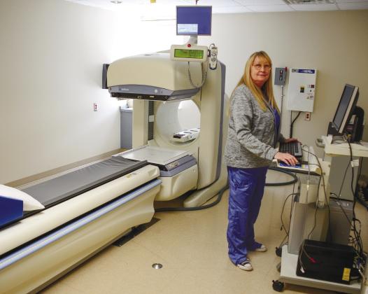 PGH Radiology Director Tina Cooper stands at the controls of a nuclear camera that can detect bone cancers, heart disease and gallbladder problems, among many other internal conditions.
