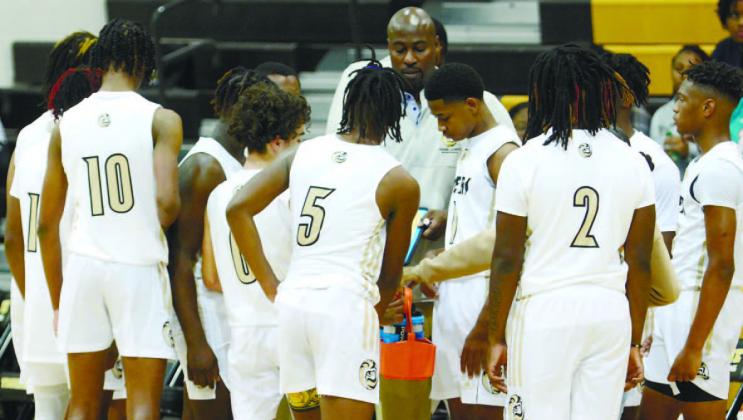 The Tigers gather during a huddle in a game against Talitaferro County earlier this season. LANCE MCCURLEY/Staff