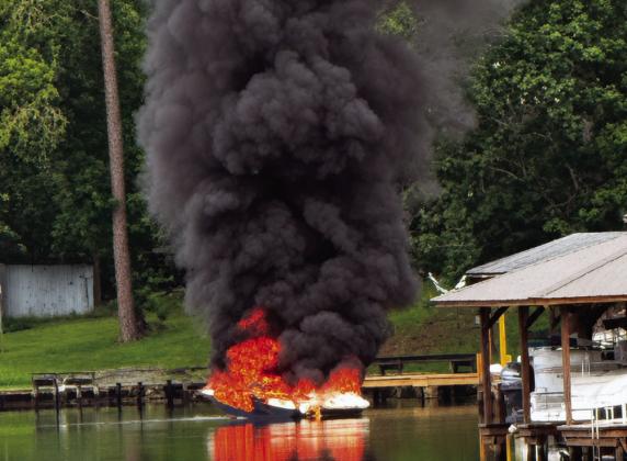 A boat adrift on Lake Sinclair is fully engulfed Friday morning before Putnam County firefighters arrive. CONTRIBUTED