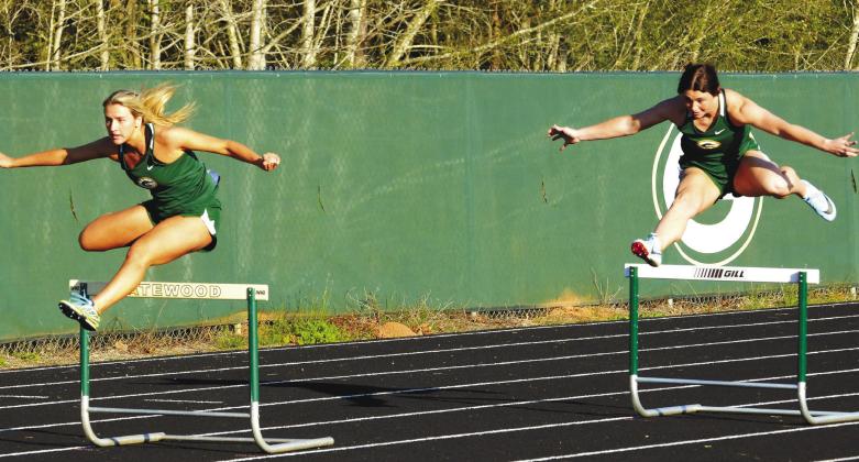 Seniors Anna Williamson (left) and Madison Hevesy (right) compete for Gatewood in the girls’ 300-meter hurdles, with Hevesy (right) finishing second while Williamson placed third. IAN TOCHER/Staff
