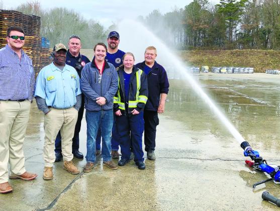 Proudly posing with the donated Blitzfire Nozzle are, from left, Gro Tec Department Manager Clayton Callaway, Gro Tec truck driver Tony Walker, EFD firefighter Tim Epps, Gro Tec Safety &amp; Environmental Manager Dustin Pennington, EFD firefighter Matt Kitchens, firefighter Jaelynn Pressley, and Eatonton Fire Chief Eugene Hubert. LYNN HOBBS/Staff
