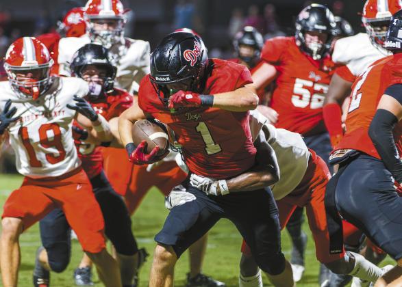 Dogs’ senior running back Alex Corrias shook off Madison County defenders in a scoring attempt during the season opener. SKYLA MORRIS/Staff