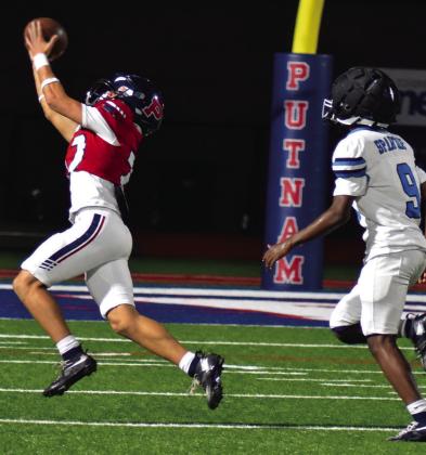 Wideout Elijah Kelly is able to reach out and pull in a pass from quarterback Caleb Reeves in the rain last Friday night against the Glenn Hill Spartans. BRANDON PARK/Staff