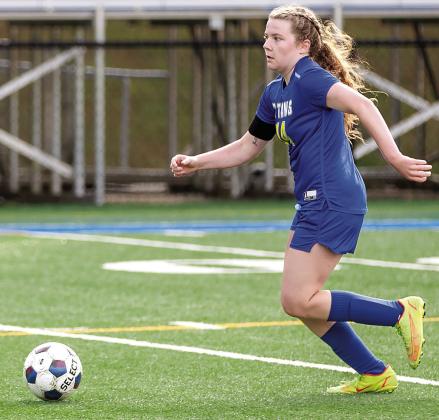 Senior Ansleigh Padgett dribbles downfield away from defenders during a match last season. SKYLA MORRIS/Staff