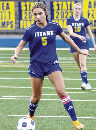 Team co-captain and senior Marley Dellinger advances the ball downfield, looking to pass to a teammate during a match last season. SKYLA MORRIS/Staff