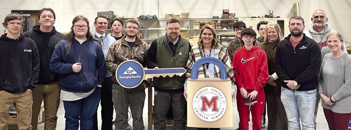 L-R: Daniel Whitten, Jack Morris, Dominic Baxter, Engineering Instructor Brian Johnson, Seth Mullins, Ben Jarrell, Georgia-Pacific Mill Manager Wesley Stone, CTAE Director Jennifer Butler, Tanner Somogy, Markus Mann, Michael Stewart, Principal Melanie Sigler, GP Human Resource Ashby Smith, Coach Greg Thompson, and Ag Mechanics Instructor Briana Stoops. CONTRIBUTED