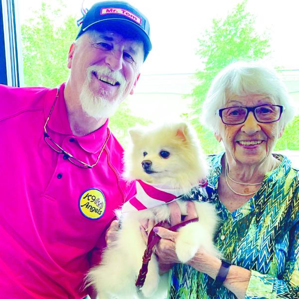 Tom Meyers and his therapy dog Ora Mae share a smile with Edna Slosvig at Lake Oconee Dentistry’s free day of dentistry for veterans, active military, and hometown heroes. CONTRIBUTED