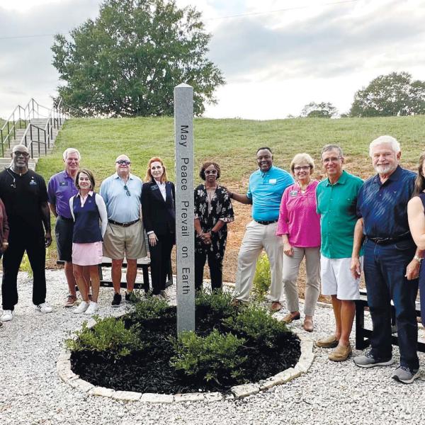 Members of the Rotary Club of Greene and Putnam Counties pose around the Rotary Peace Pole located at the Pete Nance Boys and Girls Club. CONTRIBUTED